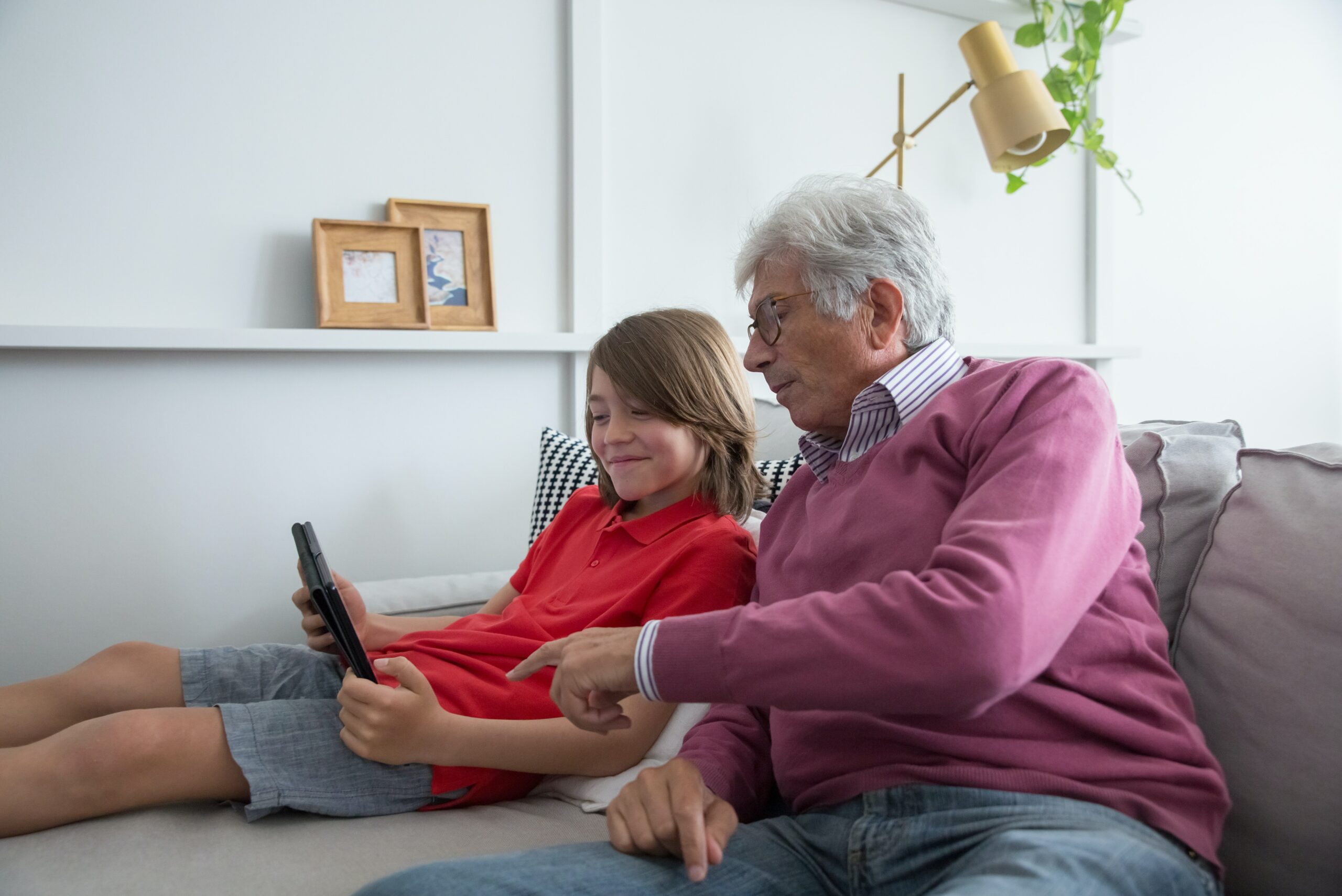 Grandparent and Grandchild looking at a device